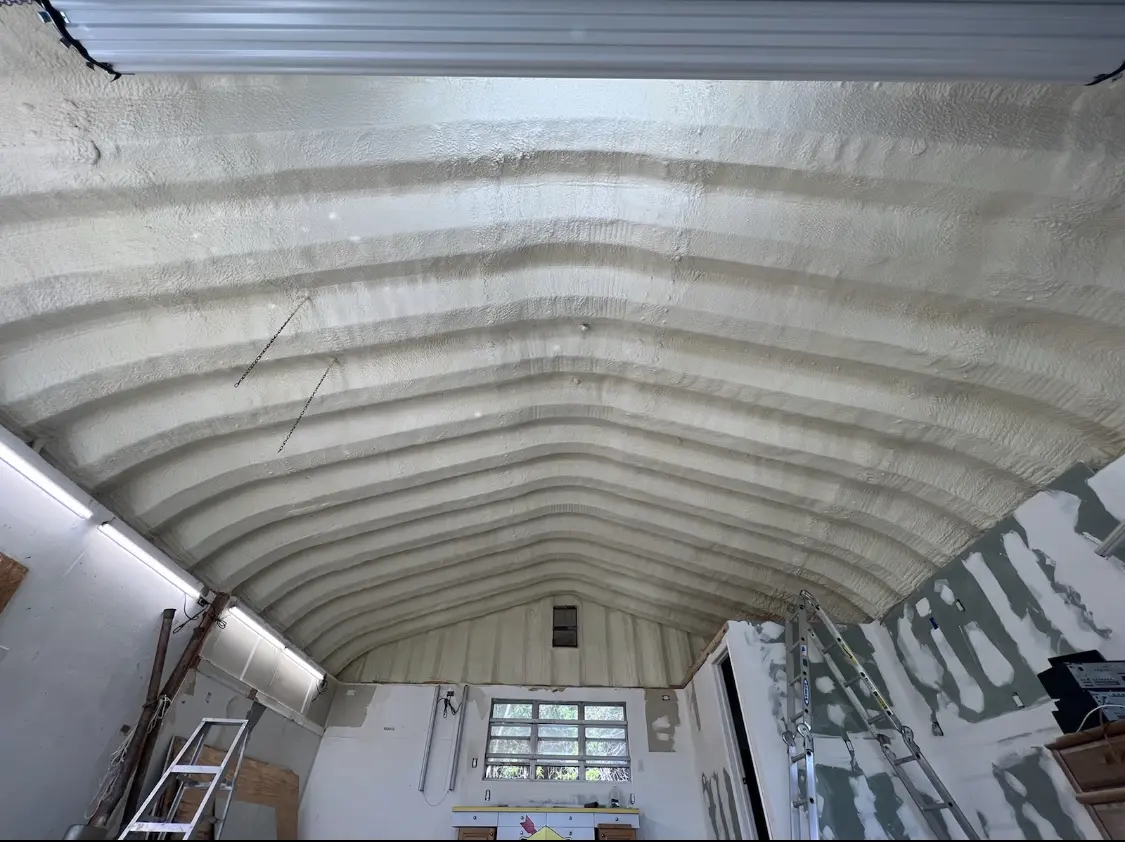 Spray polyurethane foam applied to the underside of a metal roof deck in Sweden